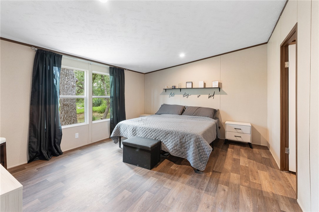 309 Tanglewood Lane Somerville, TX 77879 - Photo 9 of 21 a bedroom with a bed and a large window