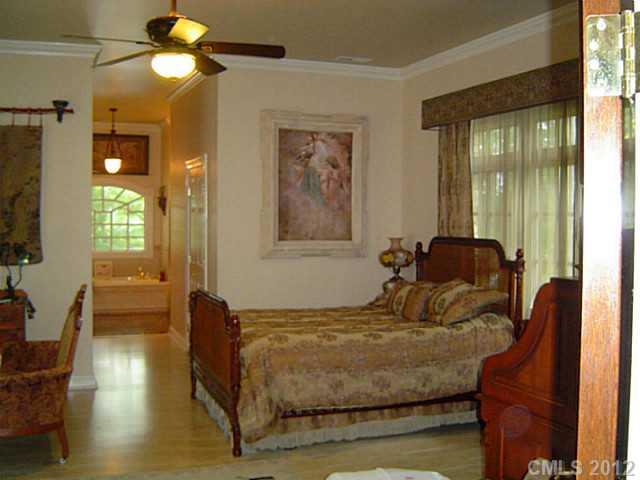 2626 Medlin Road Monroe, NC 28112 - Photo 14 of 16 a bedroom with a bed window and glass door