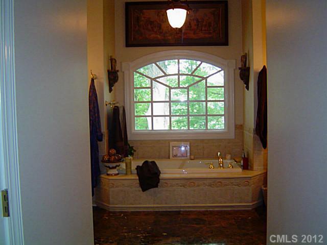 2626 Medlin Road Monroe, NC 28112 - Photo 15 of 16 a bathroom with a sink and a mirror