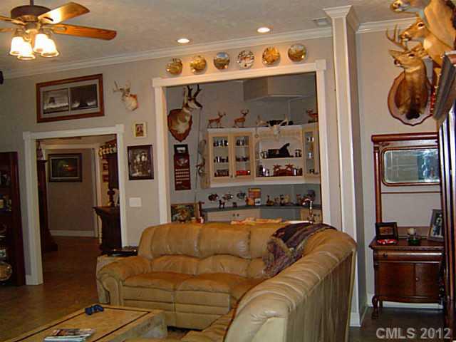 2626 Medlin Road Monroe, NC 28112 - Photo 16 of 16 a living room with furniture a flat screen tv and a fireplace