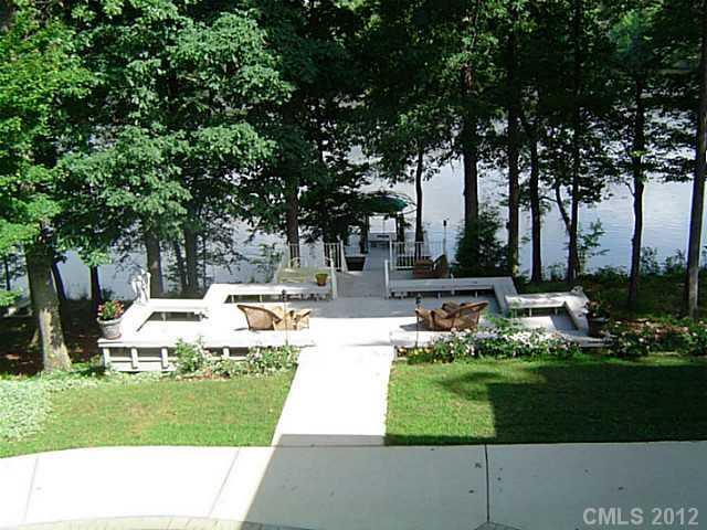 2626 Medlin Road Monroe, NC 28112 - Photo 3 of 16 a view of a white house with a big yard plants and large trees