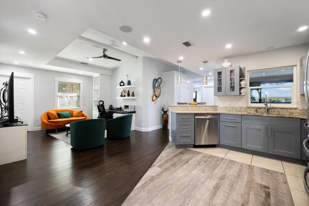 1627 Del Monte Court Venice, FL 34293 - Photo 13 of 78 a living room with stainless steel appliances kitchen island granite countertop lots of counter top space and a couch
