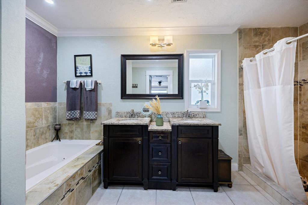 1627 Del Monte Court Venice, FL 34293 - Photo 22 of 78 a bathroom with a bathtub sink vanity and mirror