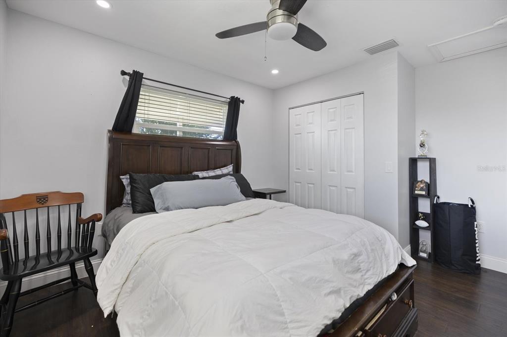 1627 Del Monte Court Venice, FL 34293 - Photo 28 of 78 a bedroom with a bed and wooden floor