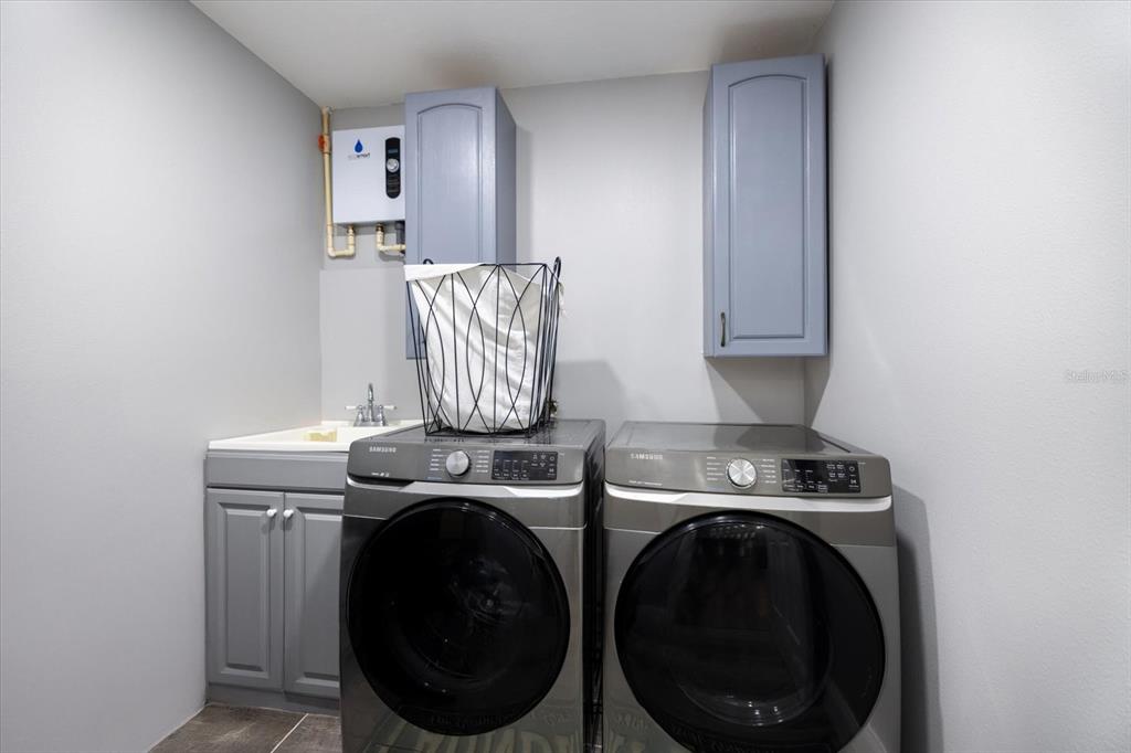 1627 Del Monte Court Venice, FL 34293 - Photo 30 of 78 a view of storage and utility room with washer and dryer