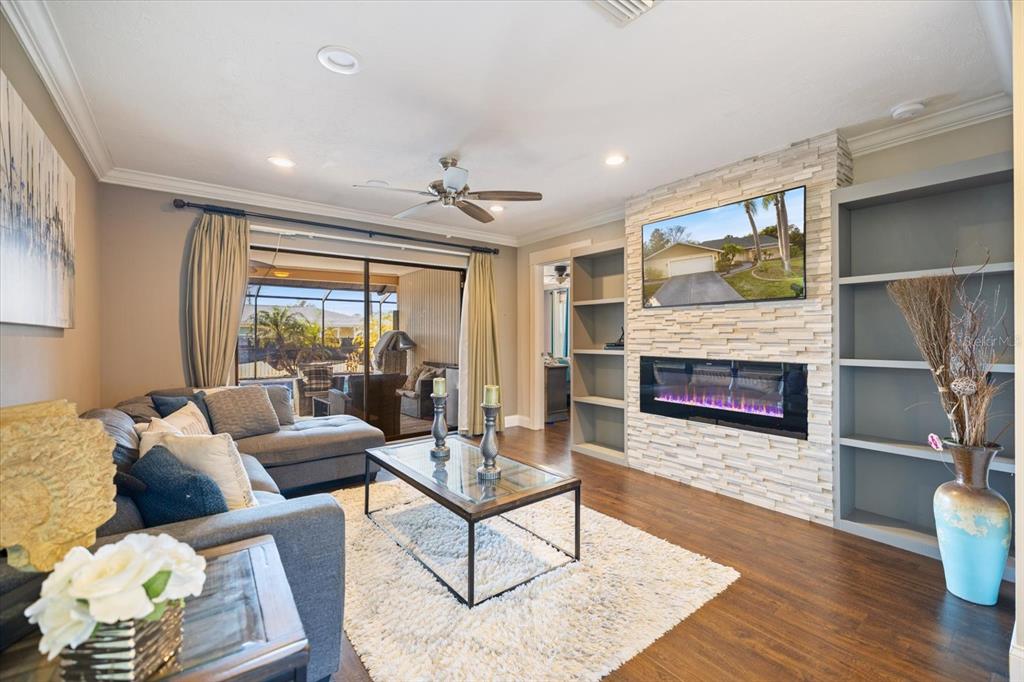 1627 Del Monte Court Venice, FL 34293 - Photo 7 of 78 a living room with furniture wooden floor and a fireplace