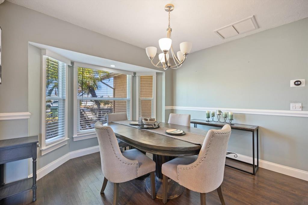 1627 Del Monte Court Venice, FL 34293 - Photo 10 of 78 a view of a dining room with furniture wooden floor and chandelier