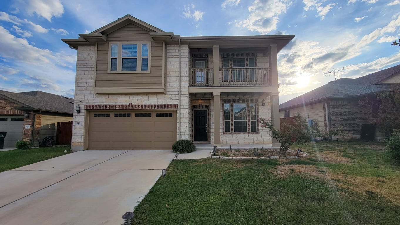 a front view of a house with a yard