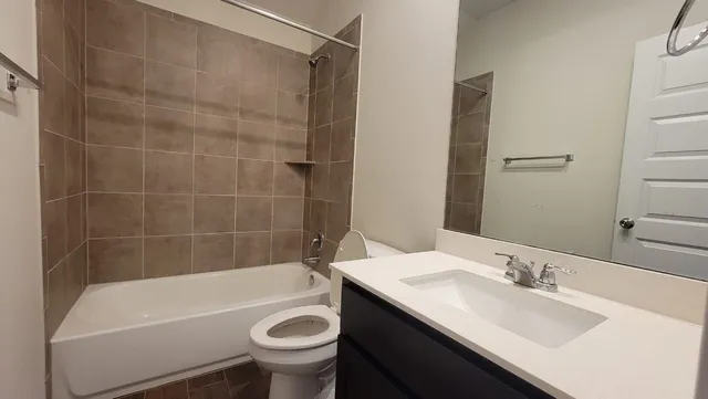 a bathroom with a sink a bathtub and a toilet