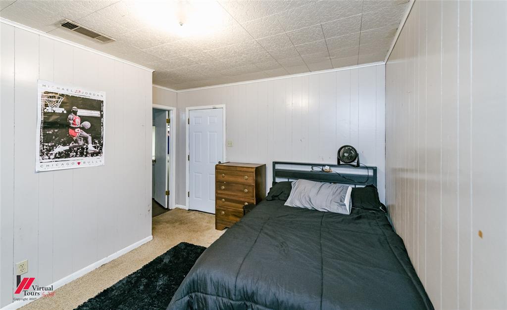 214 Ellis Drive Minden, LA 71055 - Photo 11 of 30 Bedroom featuring wooden walls, light colored carpet, and crown molding