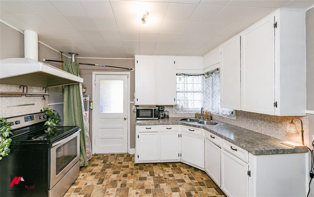 214 Ellis Drive Minden, LA 71055 - Photo 12 of 30 Kitchen with stainless steel appliances, white cabinets, dark countertops, and open shelves