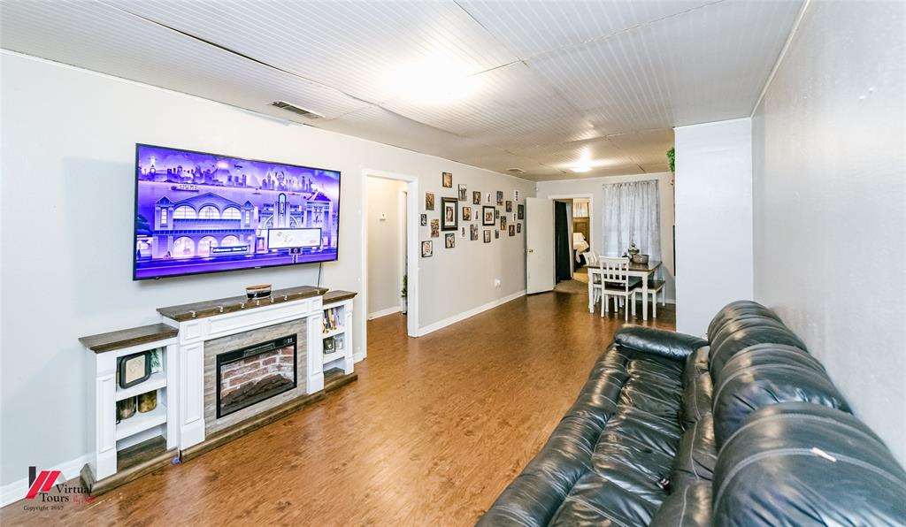 214 Ellis Drive Minden, LA 71055 - Photo 23 of 30 Living area featuring dark wood-style floors and a fireplace