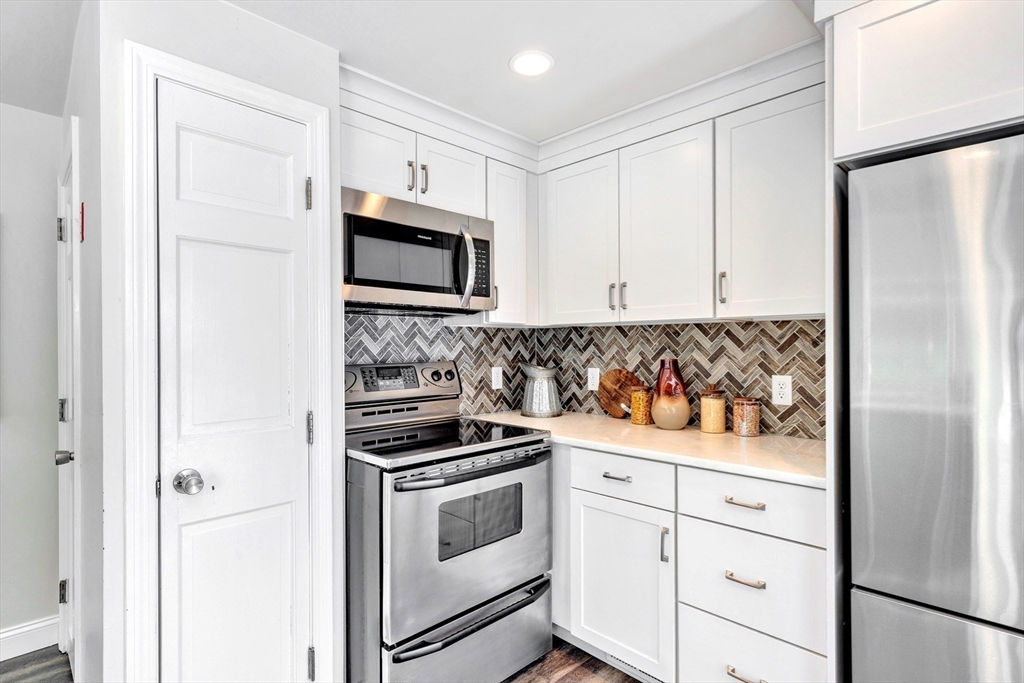 118 Woolford Road Wrentham, MA 02093 - Photo 15 of 41 a kitchen with white cabinets and white appliances