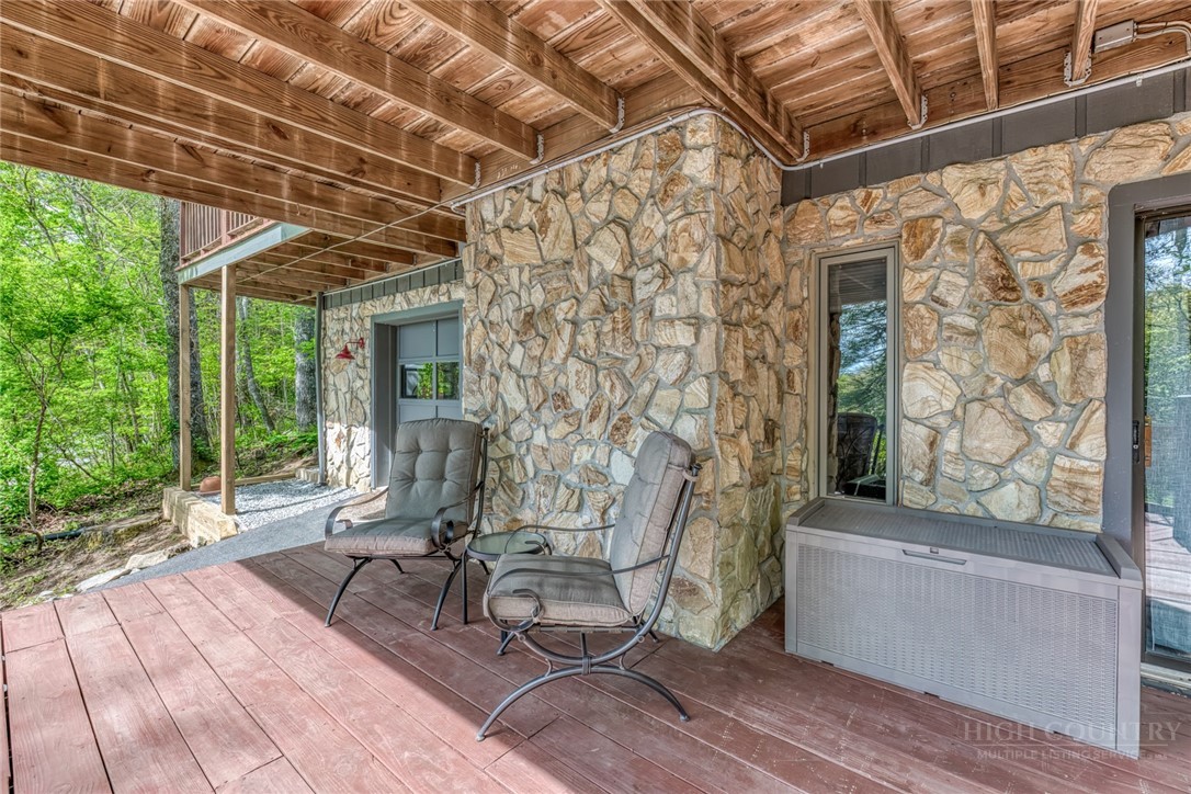 174 Spruce Pine Road Newland, NC 28657 - Photo 36 of 50 a view of a patio with table and chairs with wooden floor and fence