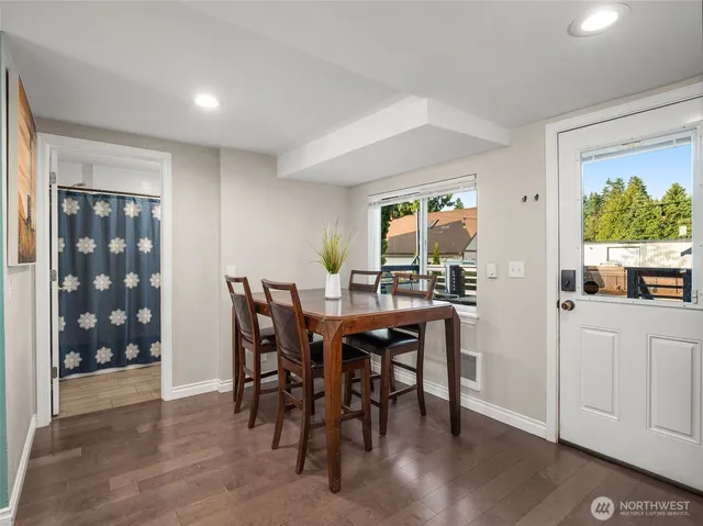 a view of a dining room with furniture and wooden floor