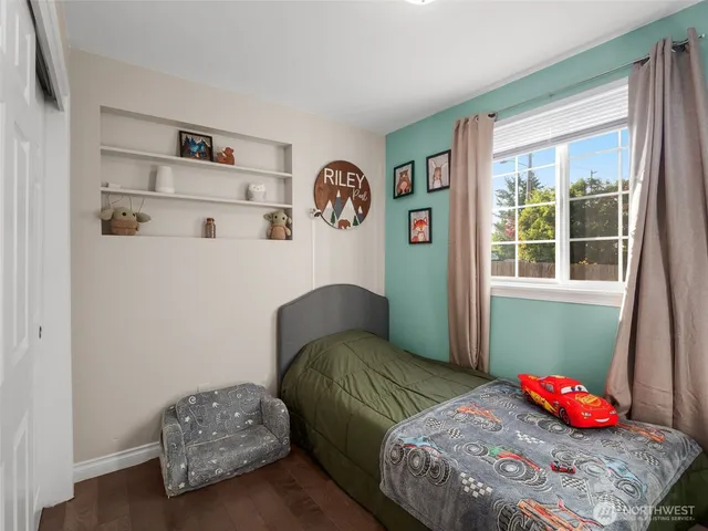 a bedroom with two beds and a window