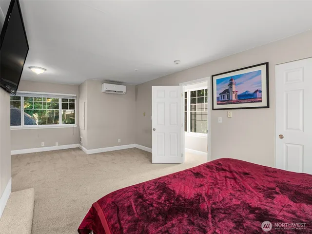 a bedroom with a large bed and a window