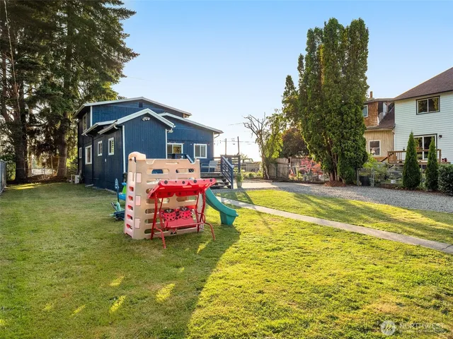 a front view of house with yard and trees