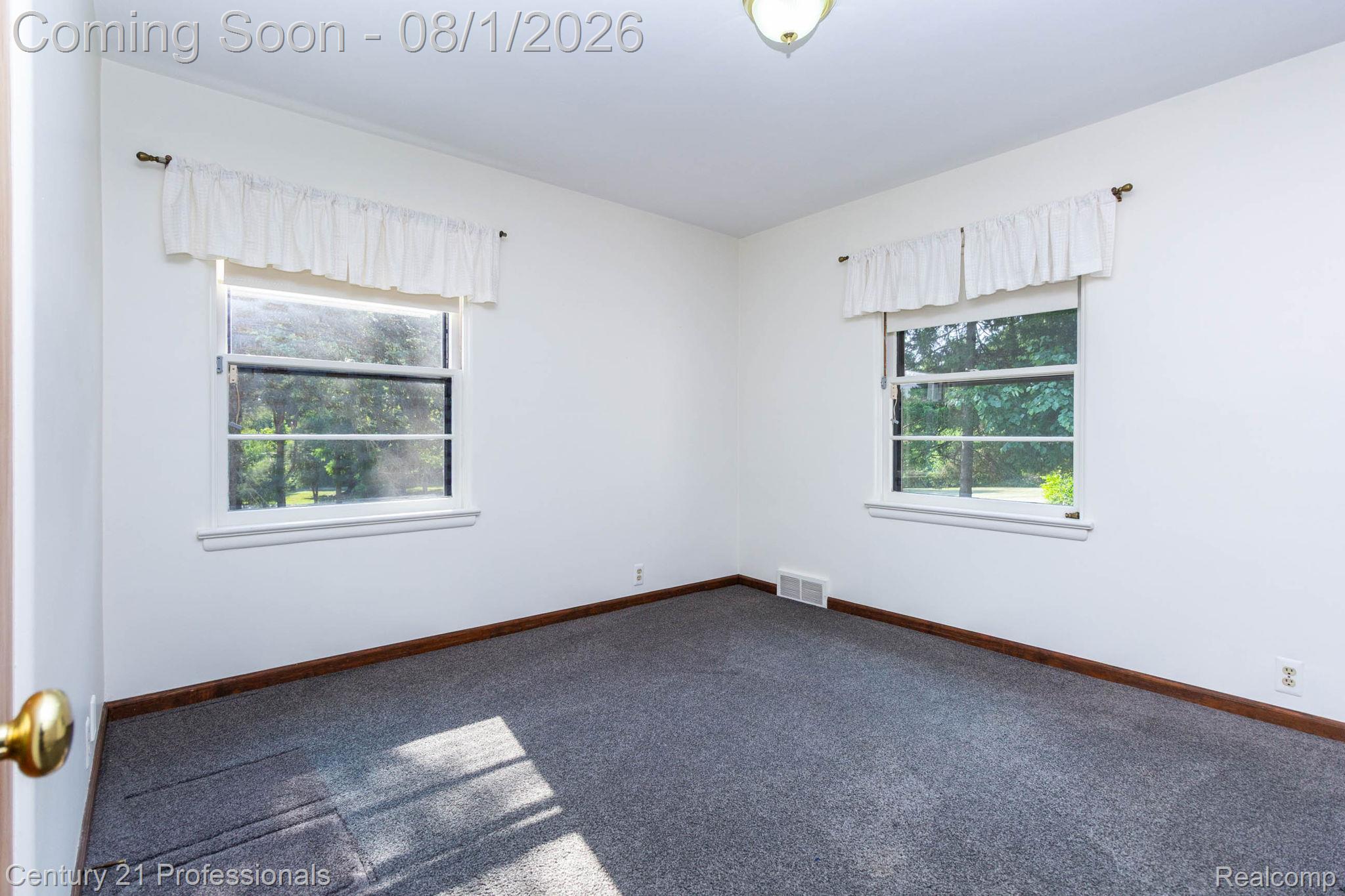 1365 East Buell Road Rochester, MI 48306 - Photo 19 of 56 Interior room featuring two double-hung windows, white walls, and gray carpet flooring