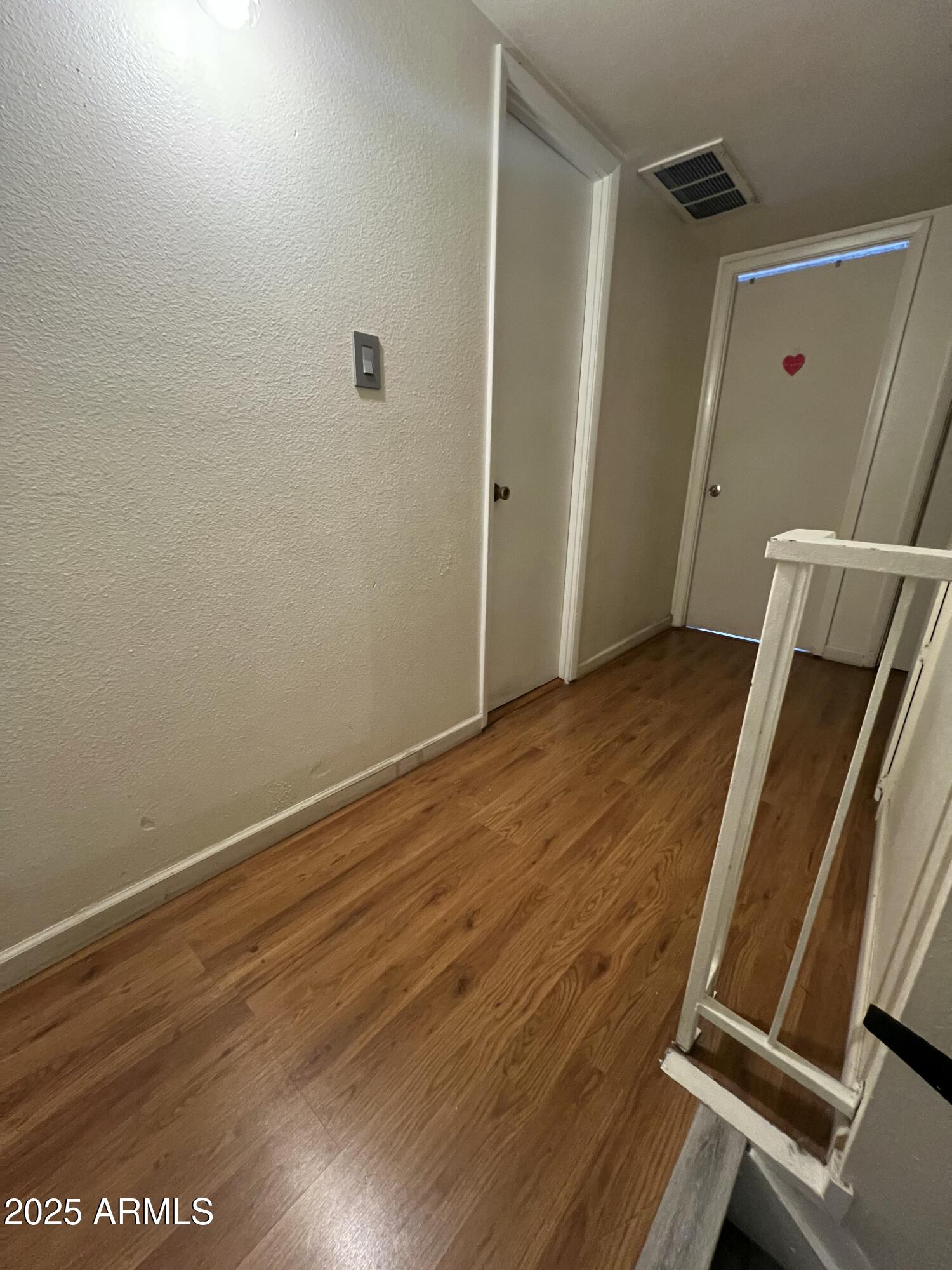 5212 North 42nd Lane Phoenix, AZ 85019 - Photo 11 of 16 an empty room with wooden floor