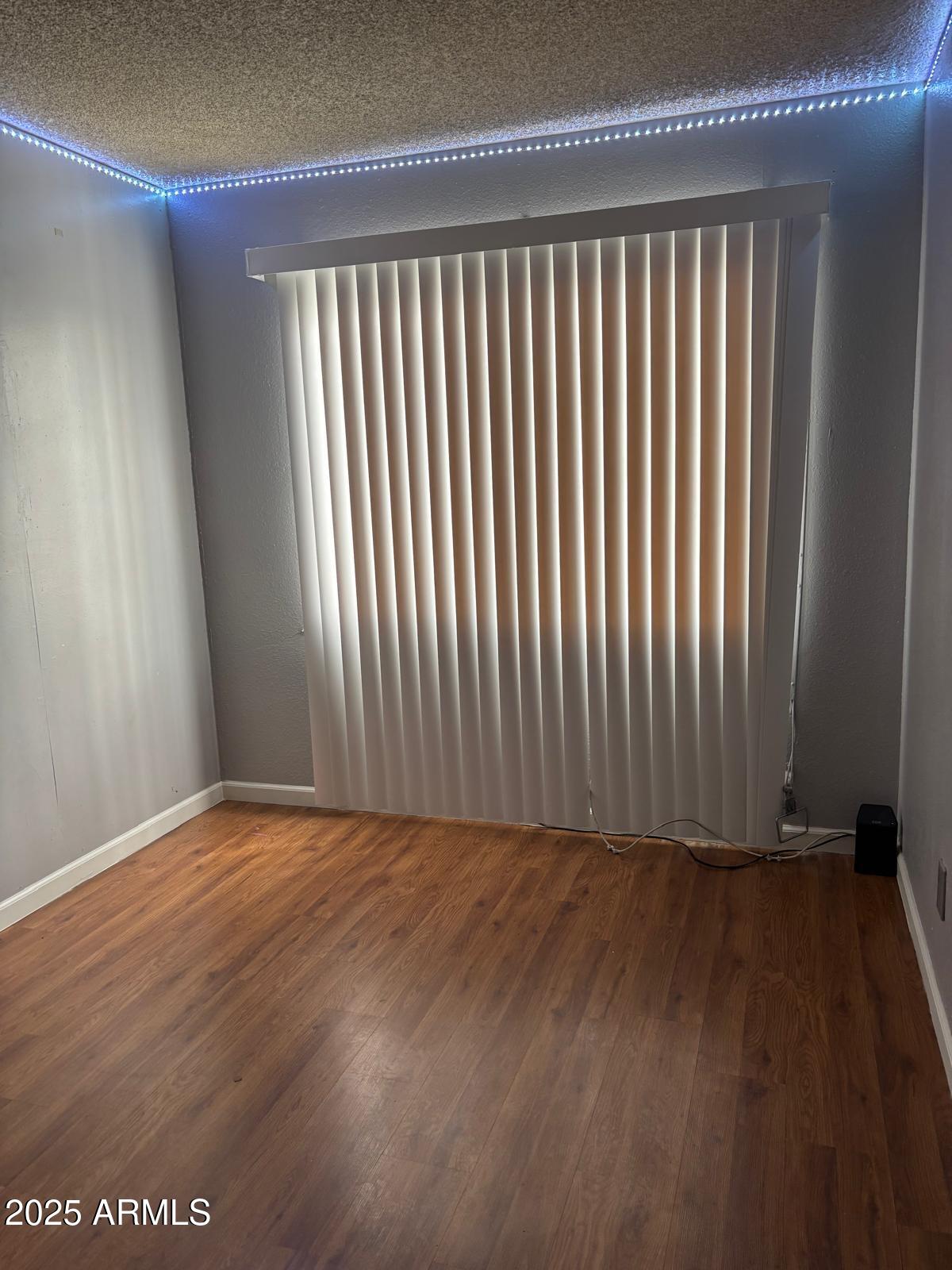 5212 North 42nd Lane Phoenix, AZ 85019 - Photo 14 of 16 a view of a room with wooden floor
