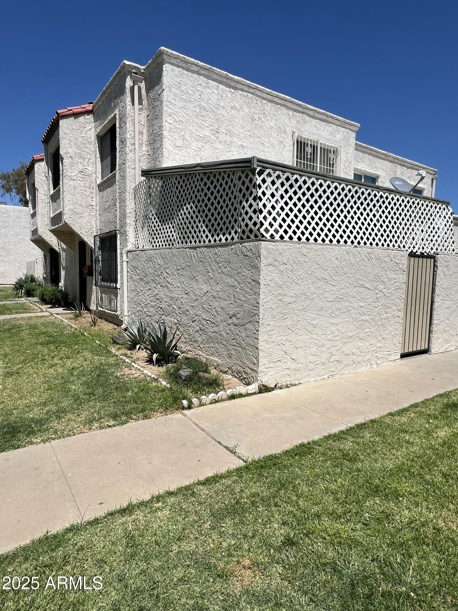 5212 North 42nd Lane Phoenix, AZ 85019 - Photo 2 of 16 a front view of a house with a yard