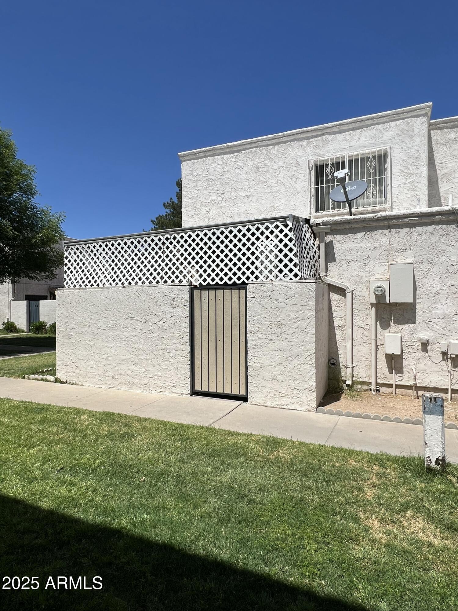5212 North 42nd Lane Phoenix, AZ 85019 - Photo 3 of 16 a front view of a house with a yard