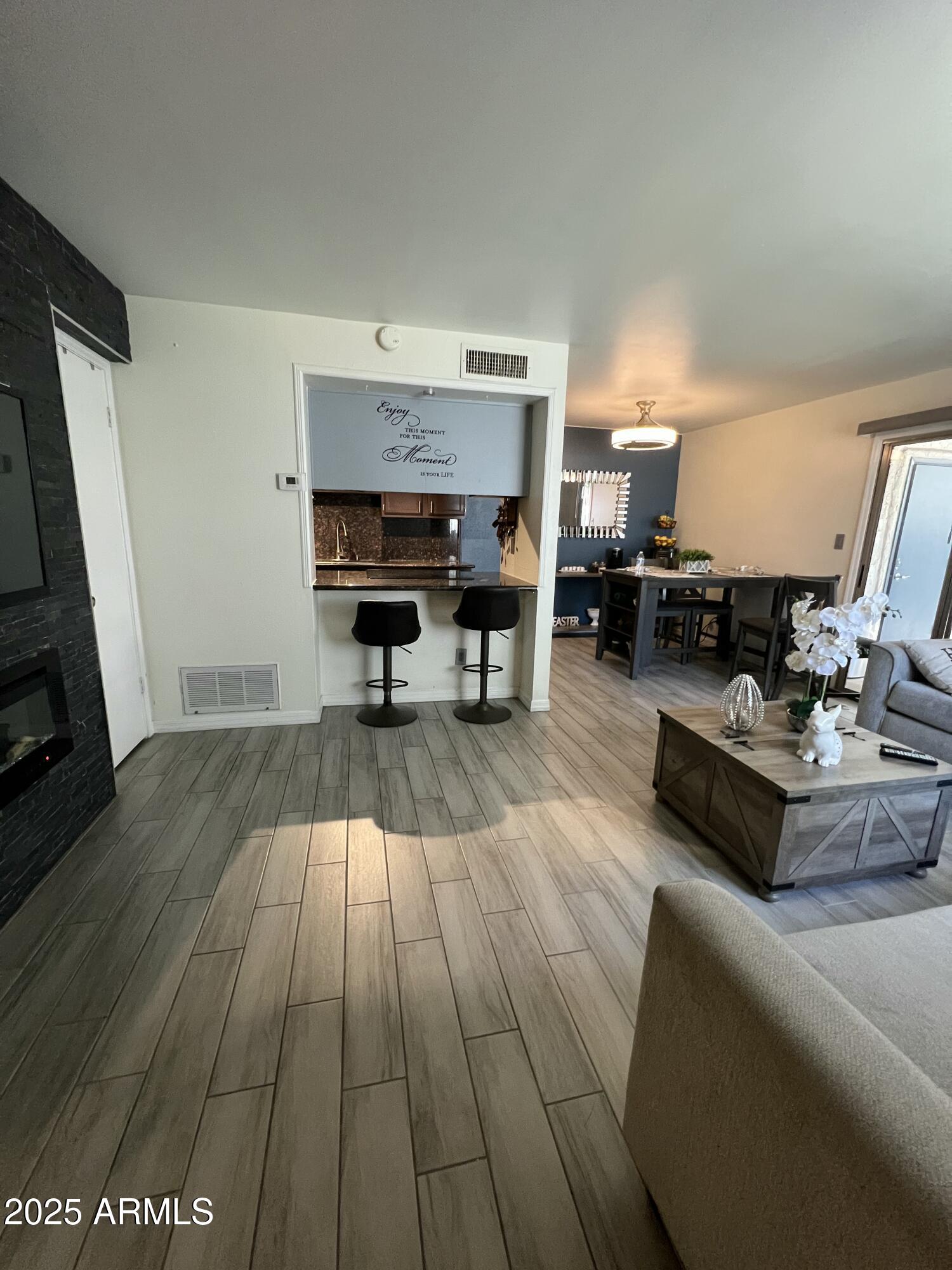 5212 North 42nd Lane Phoenix, AZ 85019 - Photo 5 of 16 a living room with furniture and a fireplace