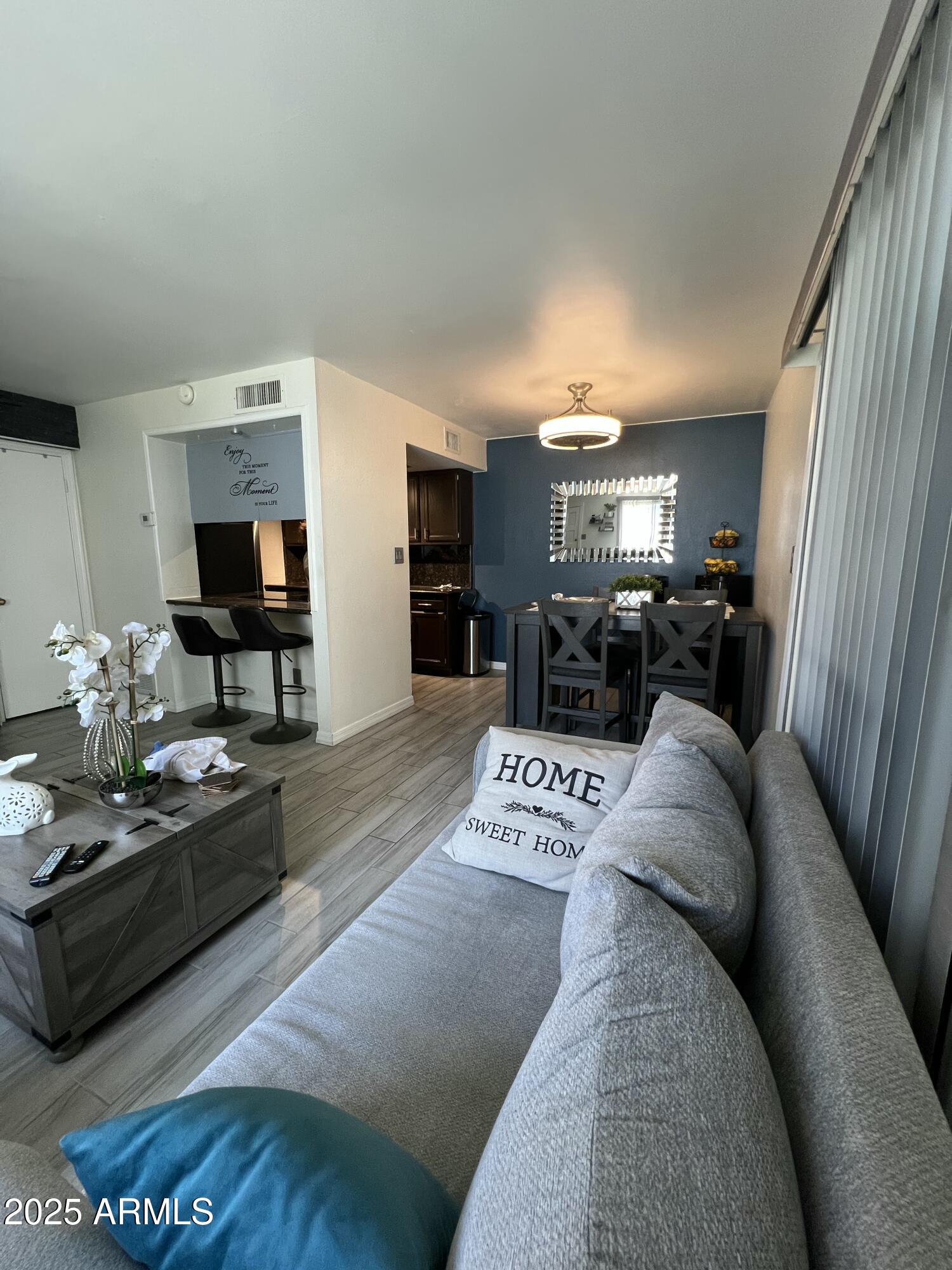 5212 North 42nd Lane Phoenix, AZ 85019 - Photo 7 of 16 a view of living room with furniture and flat screen tv