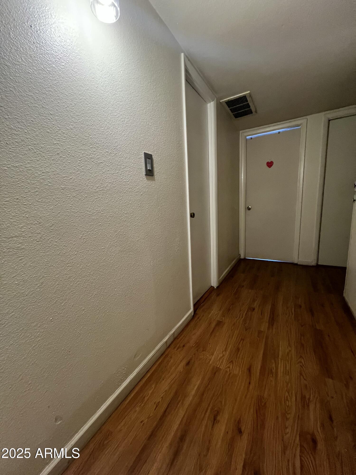 5212 North 42nd Lane Phoenix, AZ 85019 - Photo 10 of 16 a view of room with wooden floor