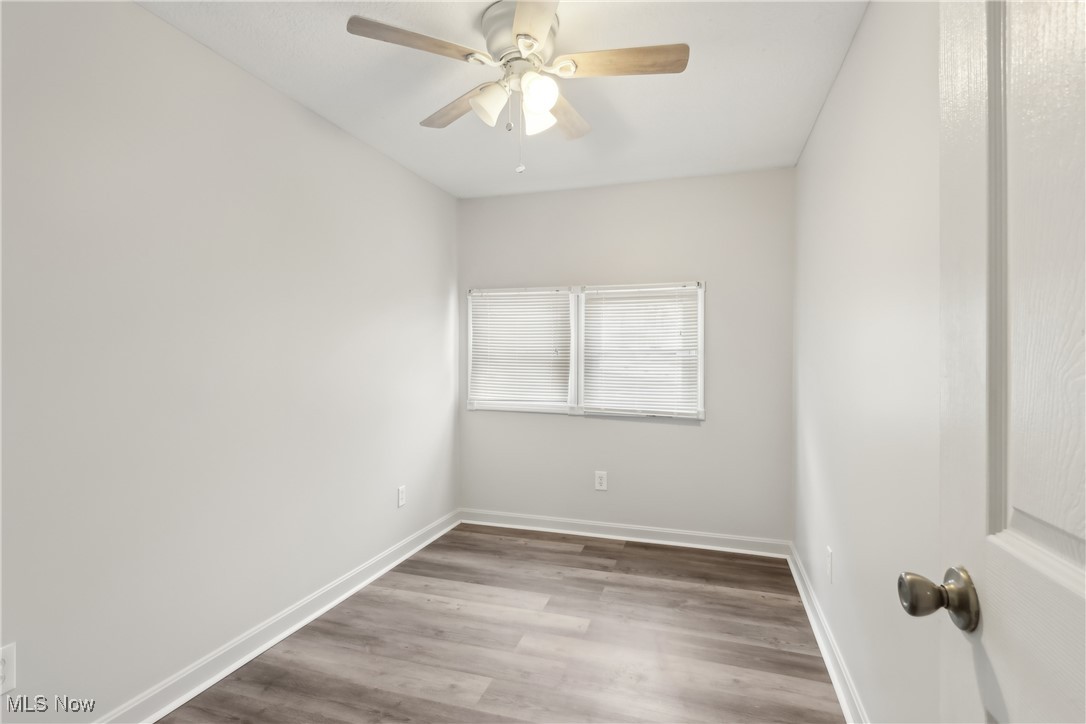 8177 South Cleveland Massillon Road, Unit 57 Clinton, OH 44216 - Photo 31 of 37 Bedroom three with LVT flooring and ceiling fan