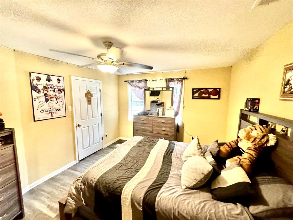 5216 Terrace Trail Sansom Park, TX 76114 - Photo 12 of 34 a bedroom with a bed and a chandelier