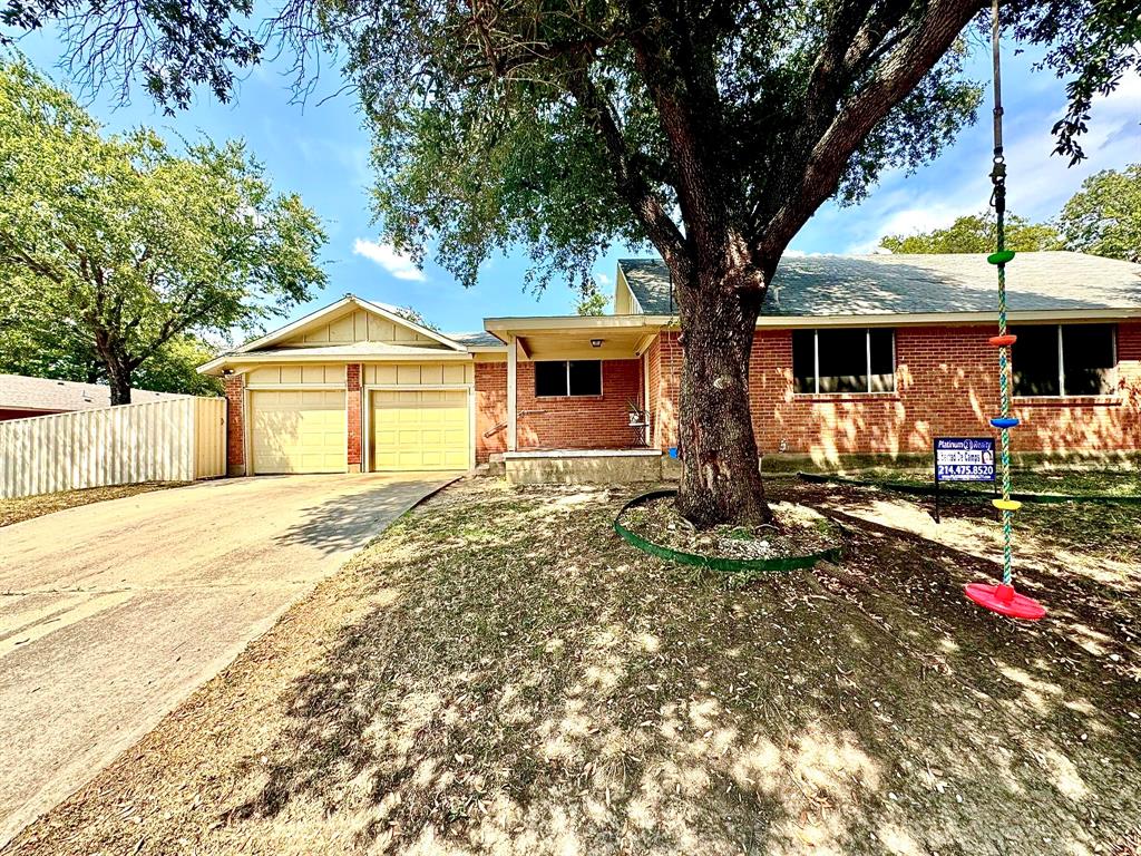 5216 Terrace Trail Sansom Park, TX 76114 - Photo 5 of 34 a front view of a house with garden