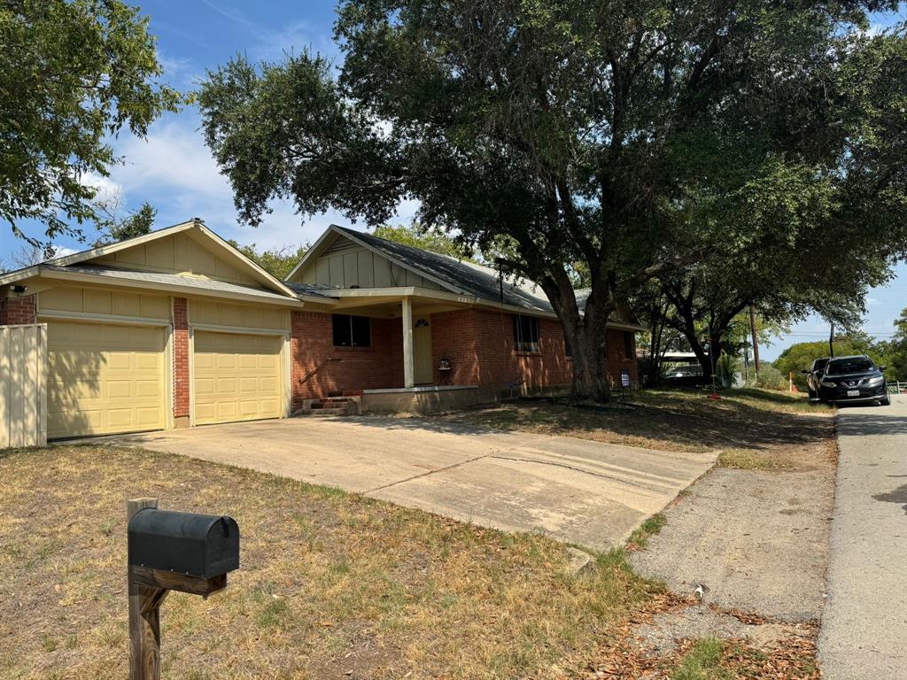 5216 Terrace Trail Sansom Park, TX 76114 - Photo 6 of 34 a front view of a house with a yard and garage