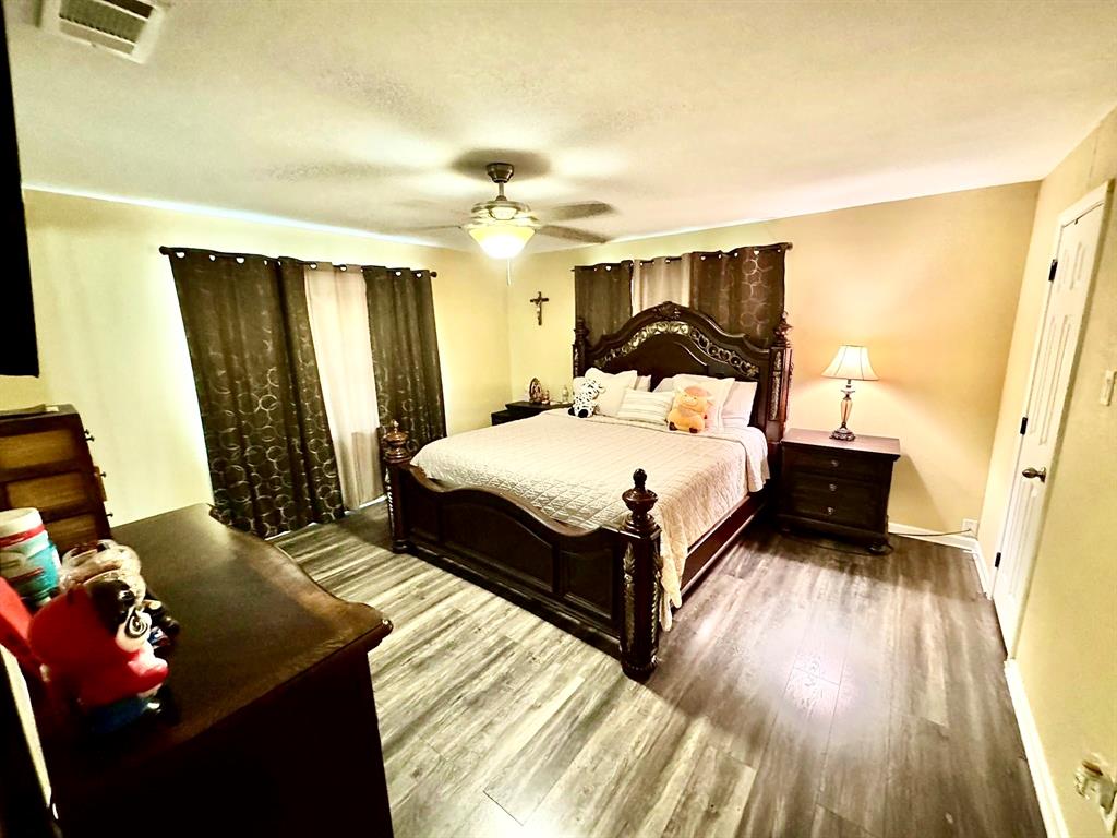 5216 Terrace Trail Sansom Park, TX 76114 - Photo 9 of 34 a bedroom with a bed and wooden floor