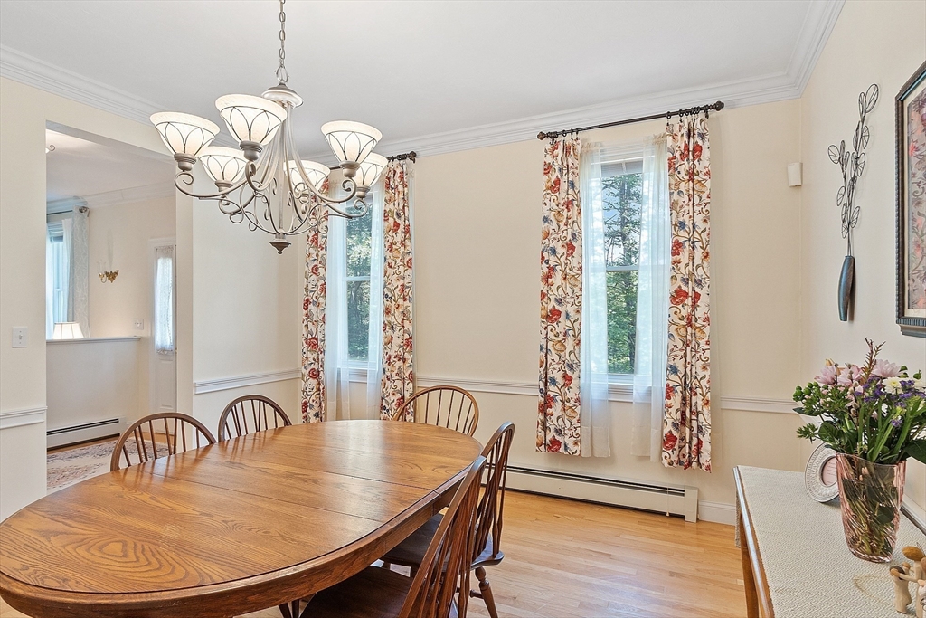 169 Narrows Road Westminster, MA 01473 - Photo 11 of 41 a dining room with furniture potted plants and wooden floor