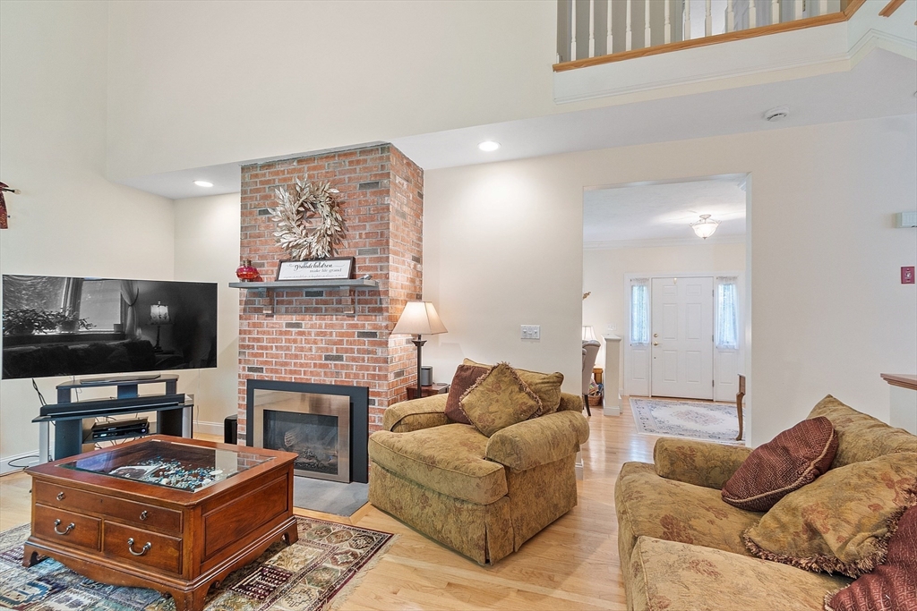 169 Narrows Road Westminster, MA 01473 - Photo 17 of 41 a living room with furniture a flat screen tv and a fireplace