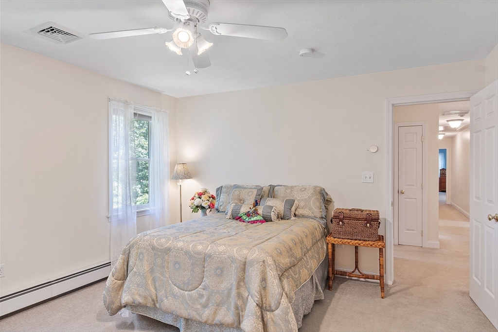 169 Narrows Road Westminster, MA 01473 - Photo 22 of 41 a bedroom with a bed and a chandelier