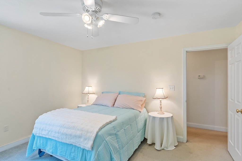 169 Narrows Road Westminster, MA 01473 - Photo 26 of 41 a bedroom with a bed and a chandelier