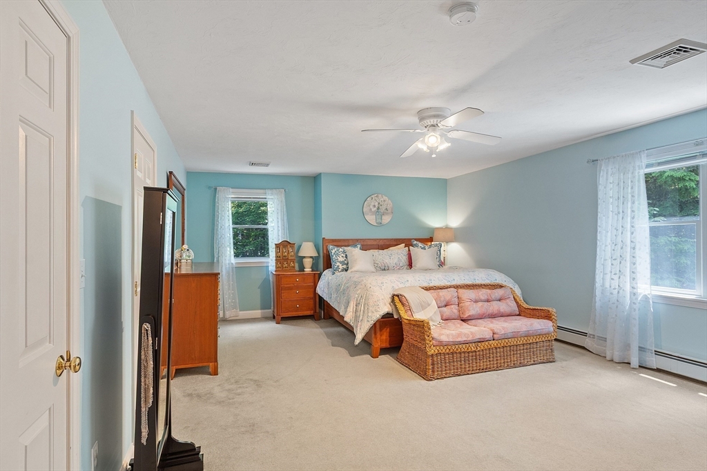 169 Narrows Road Westminster, MA 01473 - Photo 30 of 41 a bedroom with a bed and a chandelier