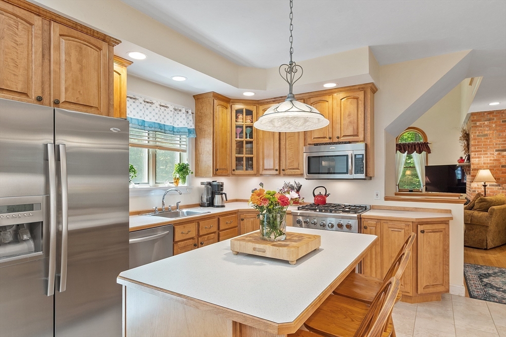169 Narrows Road Westminster, MA 01473 - Photo 7 of 41 a kitchen with kitchen island granite countertop a sink a center island stainless steel appliances cabinets and a counter top space