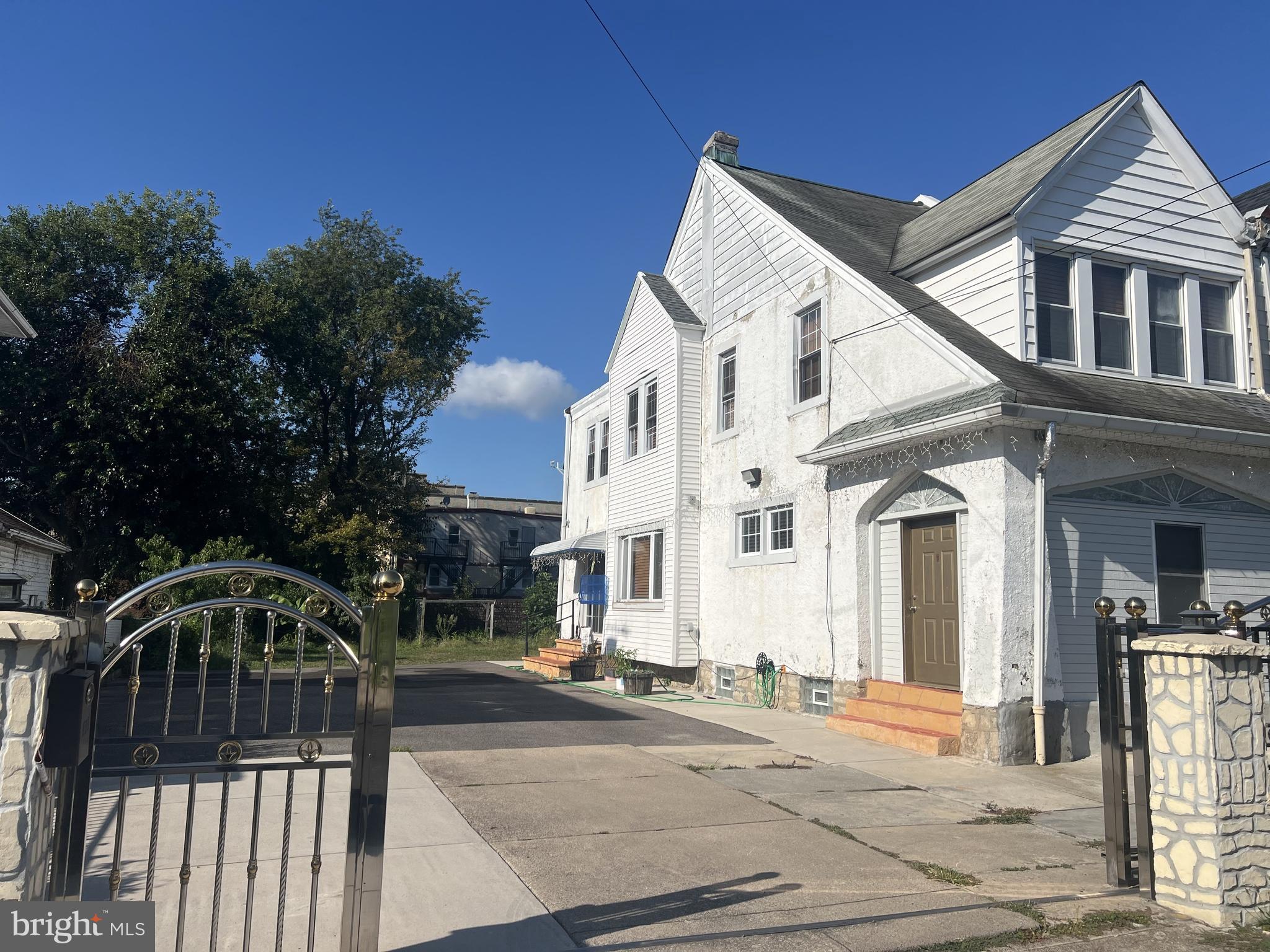 330 Sanger Street Philadelphia, PA 19120 - Photo 1 of 18 a view of a white building among the street with palm trees