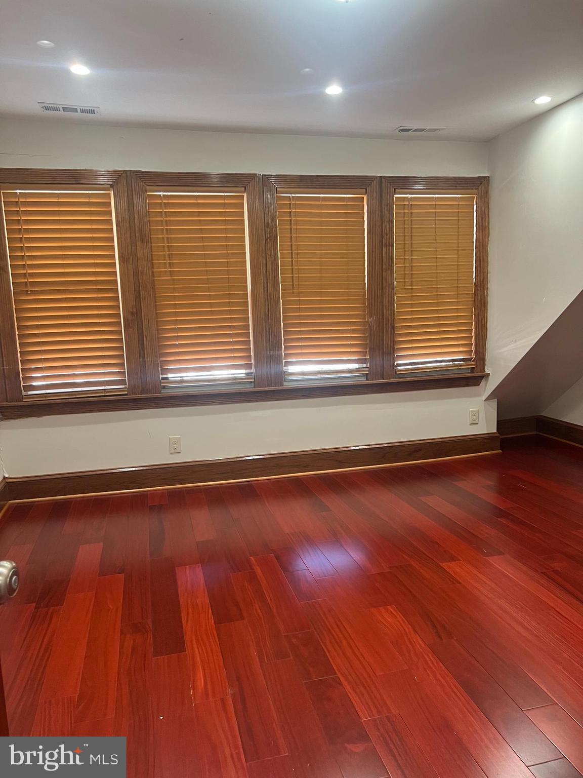 330 Sanger Street Philadelphia, PA 19120 - Photo 18 of 18 an empty room with wooden floor and windows