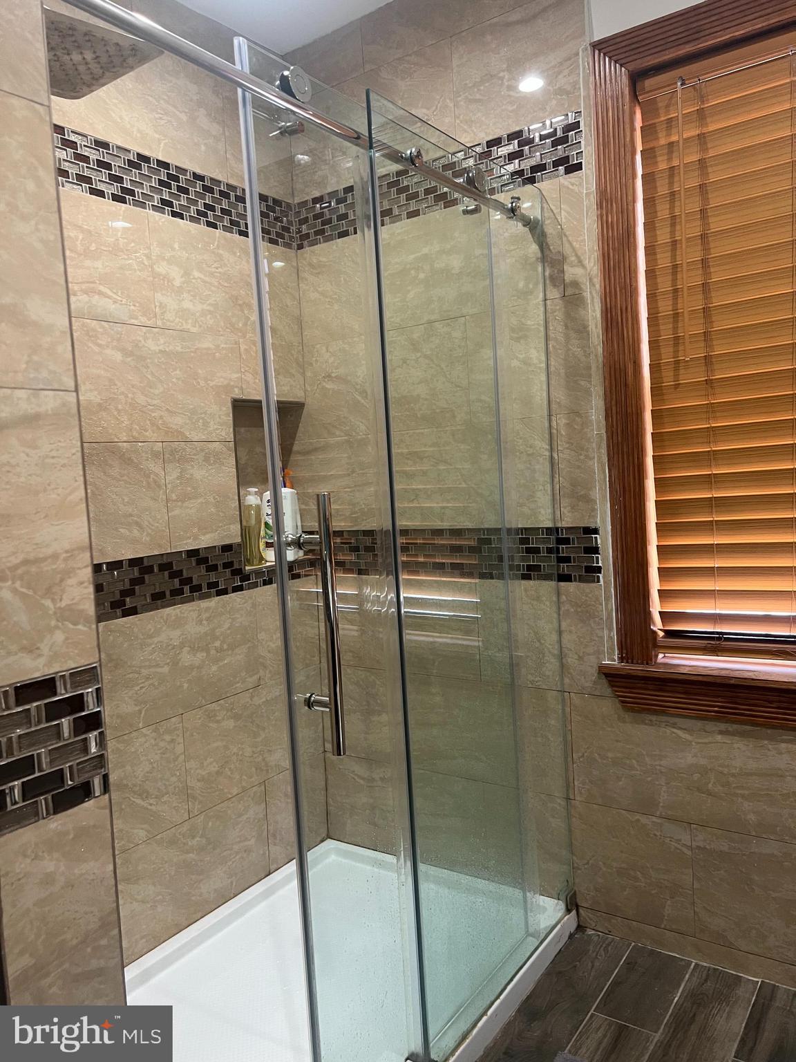 330 Sanger Street Philadelphia, PA 19120 - Photo 4 of 18 a bathroom with a glass shower door
