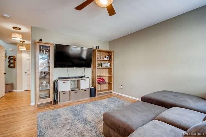 9629 Sydney Lane Highlands Ranch, CO 80130 - Photo 14 of 34 a living room with furniture and a flat screen tv