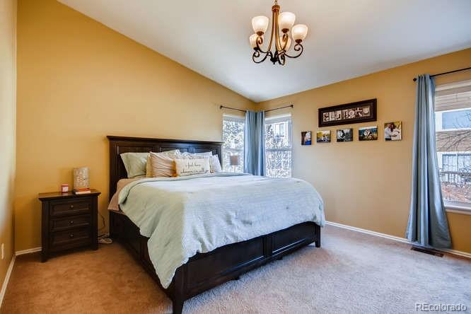 9629 Sydney Lane Highlands Ranch, CO 80130 - Photo 18 of 34 a bedroom with a bed and dresser