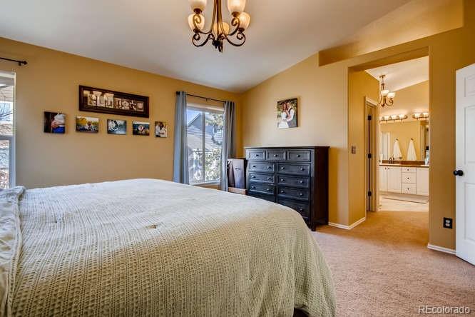 9629 Sydney Lane Highlands Ranch, CO 80130 - Photo 20 of 34 a bedroom with a bed and a television