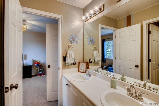 9629 Sydney Lane Highlands Ranch, CO 80130 - Photo 25 of 34 a en suite bathroom with a double vanity sink and a mirror