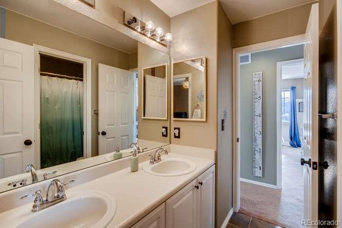 9629 Sydney Lane Highlands Ranch, CO 80130 - Photo 26 of 34 a bathroom with a double vanity sink and mirror