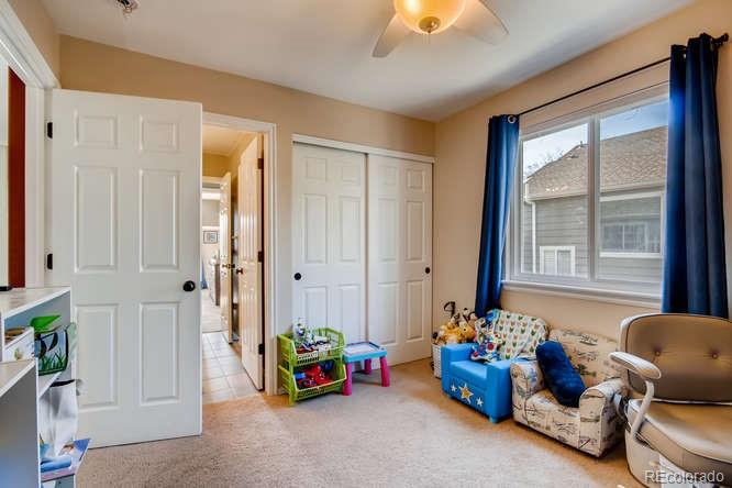 9629 Sydney Lane Highlands Ranch, CO 80130 - Photo 27 of 34 a bedroom with bed and windows